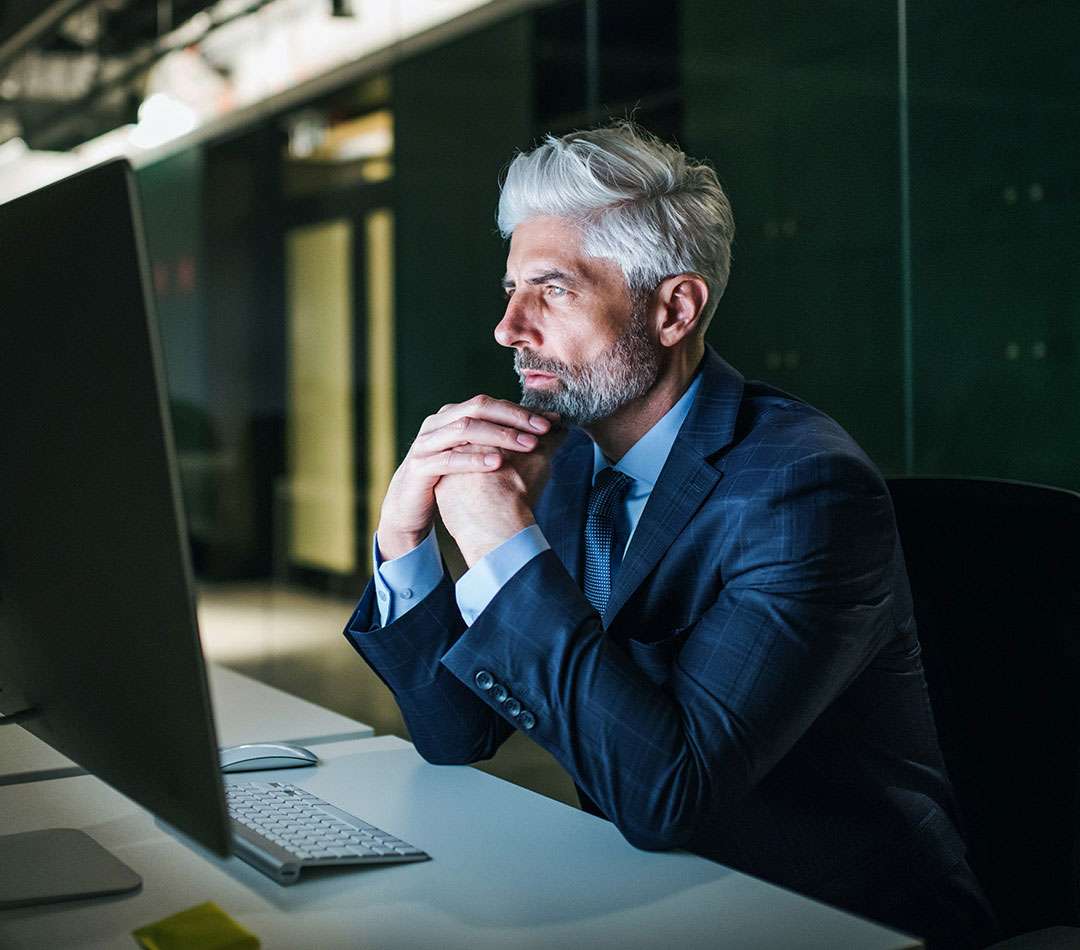 Business executive analysing data on a desktop computer