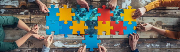 Team collaborating on puzzle pieces representing cybersecurity partnership